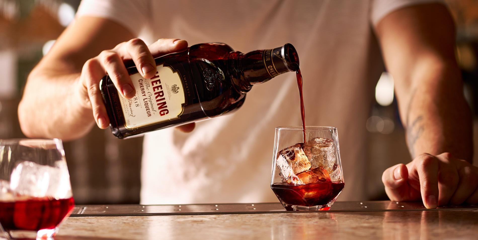 10255_Heering-banner-image-Heering-bottle-and-pouring-w